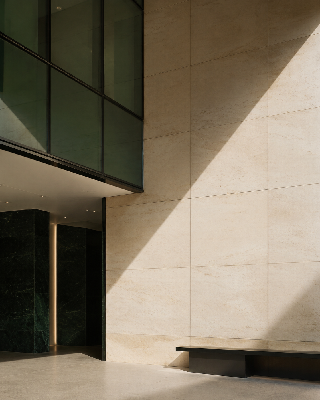 Modern limestone and green glass architecture in warm sunlight